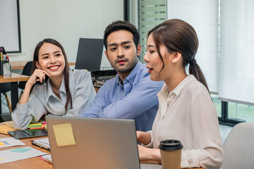 Fototapeta premium Young business group explaining new business ideas to peers. Business people discussing in meeting room.