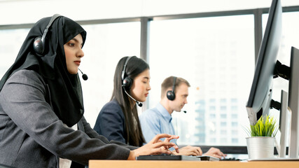 Muslim woman work as call center. Customer service executive working at office. Young friendly operator woman agent with headsets working in call centre. Clean office concept
