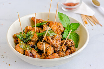 Deep Fried Taiwanese Chicken with Basil Leaves and Seasoning Close Up Photo