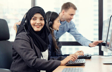 Muslim woman work as call center. Customer service executive working at office. Young friendly operator woman agent with headsets working in call centre. Clean office concept