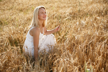 Beautiful girl in a white dress. Woman in a summer field