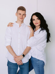 brunette beautiful stylish woman with teen son in white shirts and jeans. Family, style, relative concept