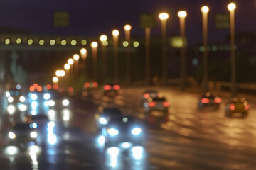 Defocused photography of Moscow cityscape in night time. Big traffic. Street is filled by cars. Blurred motion of cars at motorway. Frontal and back / rear view