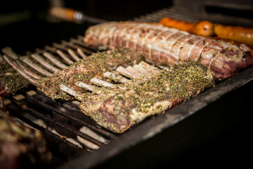 Delicious meat grilling on the barbecue. The tender, strongly seasoned meat will be served as lamb...