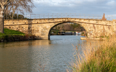 Fototapeta na wymiar Pretty bridge over the Canal du Midi, France in the village of Roubia