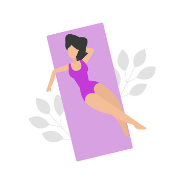 Woman in purple swimsuit lying on the towel 
