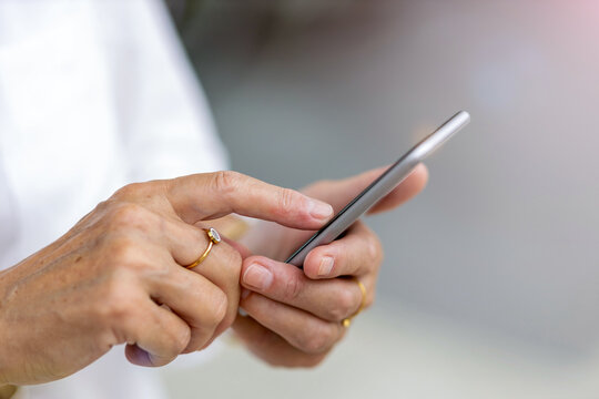 Senior woman's hands holding a smart phone
