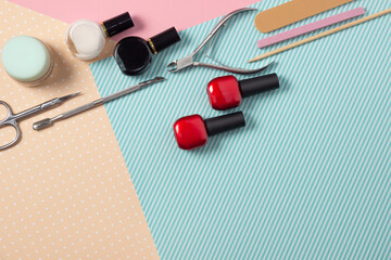 Tools for manicure on a pink and blue background. Nail files, scissors and nail polishes top view. Nail Salon, Beauty Salon