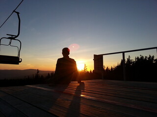 silhouette of a man on a bench