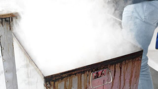 Smoking Poon fish lifting of the lit of the smoker