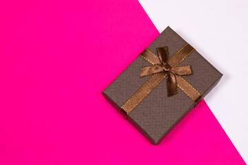 Gift on a multicolored background. Surprise in a festive package.