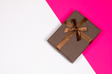 Gift on a multicolored background. Surprise in a festive package.