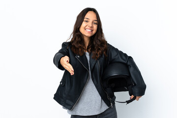 Young woman holding a motorcycle helmet over isolated white background shaking hands for closing a good deal