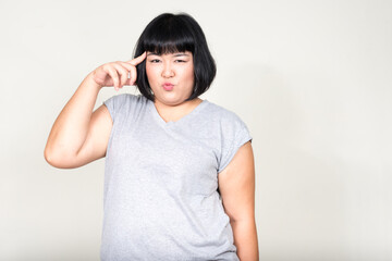 Portrait of young beautiful overweight Asian woman