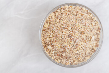 Grated almonds in the bowl on the table