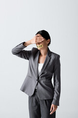 businesswoman with sexism lettering on duct tape covering eyes isolated on white