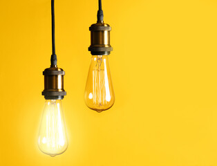 Idea concept. Light bulbs on yellow background, space for text