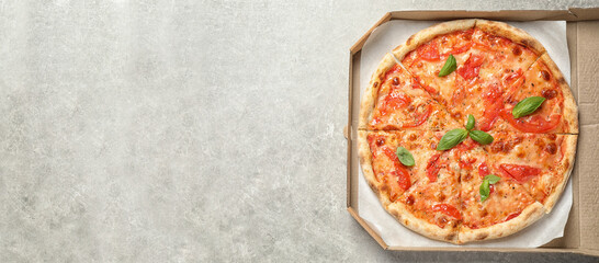 Top view of hot delicious pizza on light marble table, space for text. Banner design