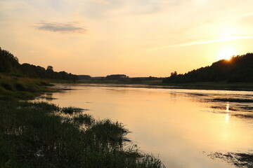 Fototapeta na wymiar Sunny evening on the river in the countryside