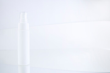 White unbranded flacon on light mockup. Facial, body care cosmetics bottle with dispenser. Blank...