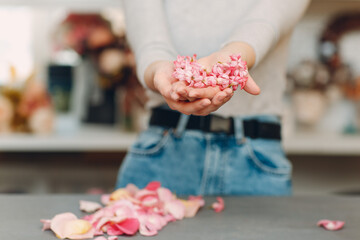 Pink hyacinth flower petals in woman hands.