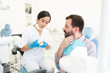 Obraz premium Man Discussing With Orthodontist During Checkup