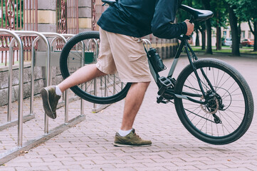 Man steals an unfastened bicycle in the city.