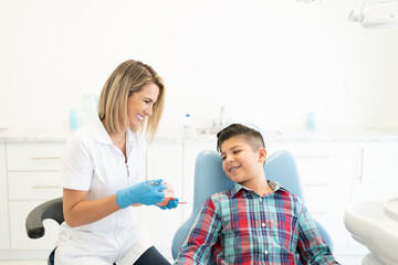 Dentist Explaining Patient At Clinic