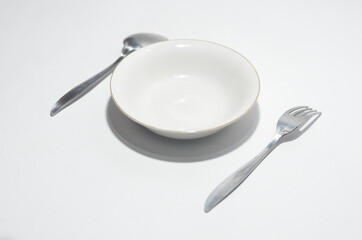Table Dish with spoon, fork and plate on isolated white background
