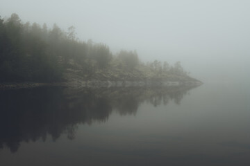 Obraz na płótnie Canvas Fog over the lake. Early morning on Ladoga lake in Karelia, Russia. 