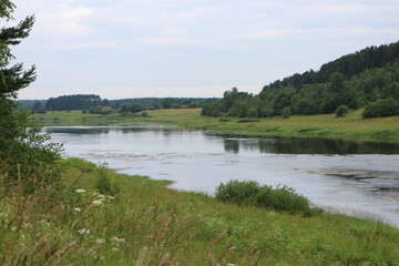 Cloudy day with clouds on the river in the countryside