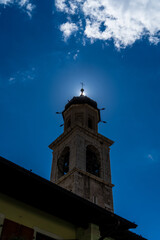 Sun behind the cross of a church