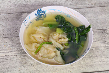 Asian traditional Wonton soup with herbs