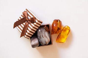 gemstones amber agate in a gift box on a white background