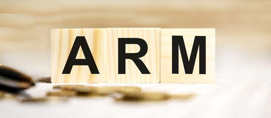 ARM - acronym from wooden blocks with letters, Advanced RISC Machine ARM concept chip architectures microprocessor technology, top view on grey background