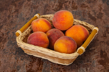 Peach heap in the wooden basket
