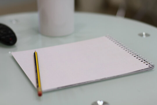 Pencil with white pages notebook without lines