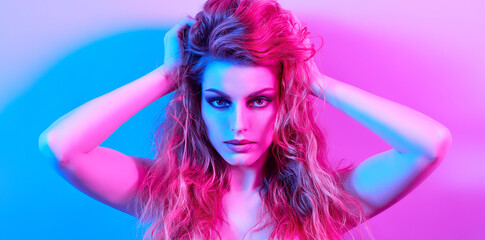 High Fashion. Woman in colorful neon light, make-up. Sexy girl, stylish wet hair, trendy makeup. Party disco neon style. Creative art beauty portrait, fashionable model face, bright make up