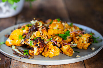 Roast cauliflower salad with red onion, parsley and almond flakes