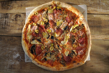 tasty Italian pizza on a wooden background top view