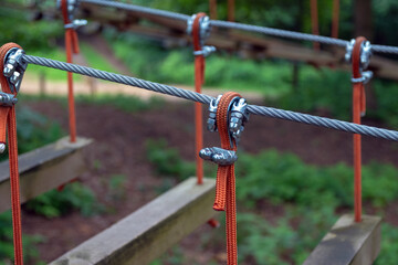 Fototapeta na wymiar Rope holding a log bridge, part of the cableway. Close-up. Extreme sport.