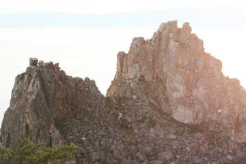 Baikal Lake in summer. View of the natural landmark of Olkhon Island - Shamanka Rock. Lake natural background. Beautiful landscape background with copy space