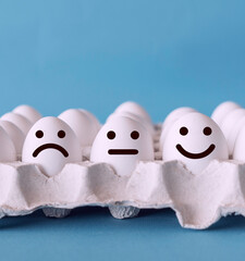 Customer service evaluation and satisfaction survey concepts. Unhappy normal and happy faces on the eggs with blue background.