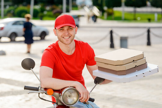 Portrait of pizza deliverer. Young man, dressed in a uniform