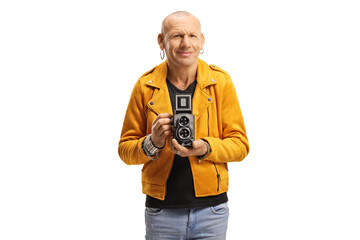 Bald man holding an old fashioned camera recorder