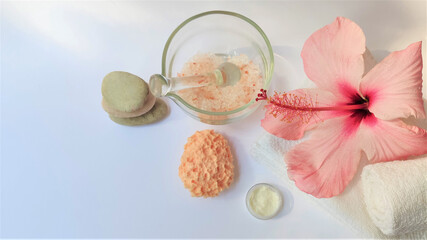 Spa setting and Spa background composition with hibiscus pink flower on white background. Banner. Copy space.