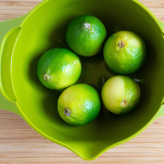 limes in a green bowl 