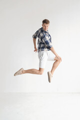 Stylish dancer man jumping in light syudio