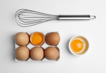 Flat lay composition with chicken eggs on white background