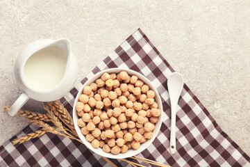 Corn balls with milk in jar and wheat ears on grey background